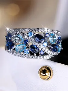 A white gold and blue synthetic zirconia texture ring with Sparkling Zircon Inlay is fashionable, high-end and simple, suitable for women to wear during proposals, travels and daily life