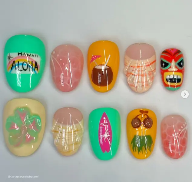 Tropical Hawaiian nail art featuring aloha vibes, coconuts, tiki masks, hibiscus flowers, surfboards, and beachy patterns in bright summer colors