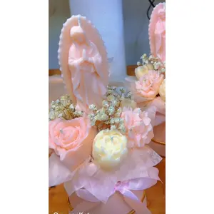 Floral arrangements in candles with the Virgin Mary