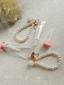 One transparent empty lip gloss tube, toothpaste shape, with a pearl keychain pendant; transparent ice cube-shaped empty lipstick tube, individually packed, refillable lip balm tube, twist-off casing, plastic material, squeeze-type dispenser